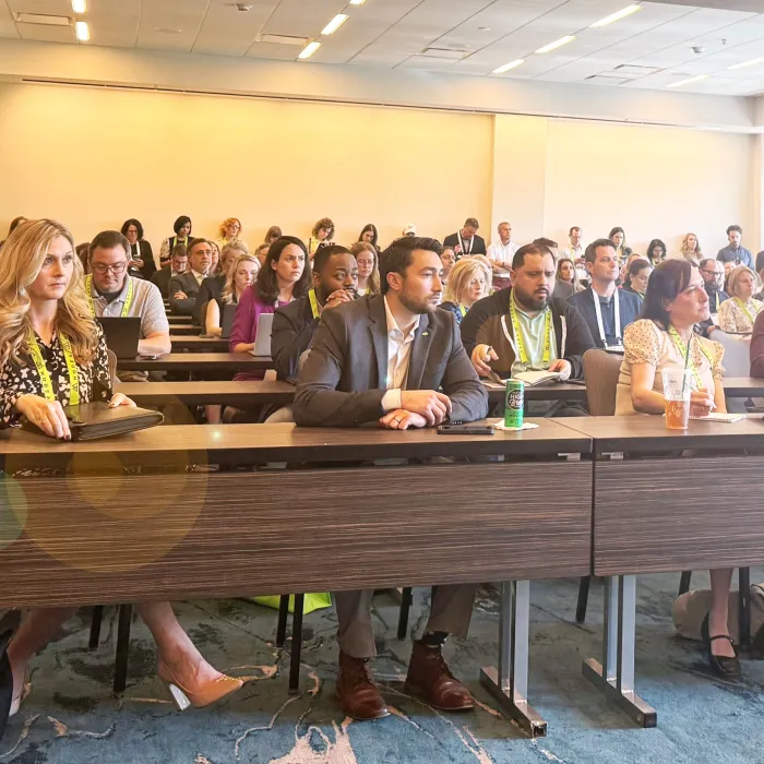people at a conference listening to a presentation