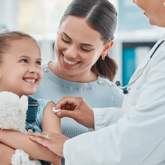 child with parent and doctor everyone is happy
