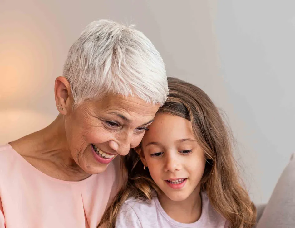Grandmother and child looking at a tablet