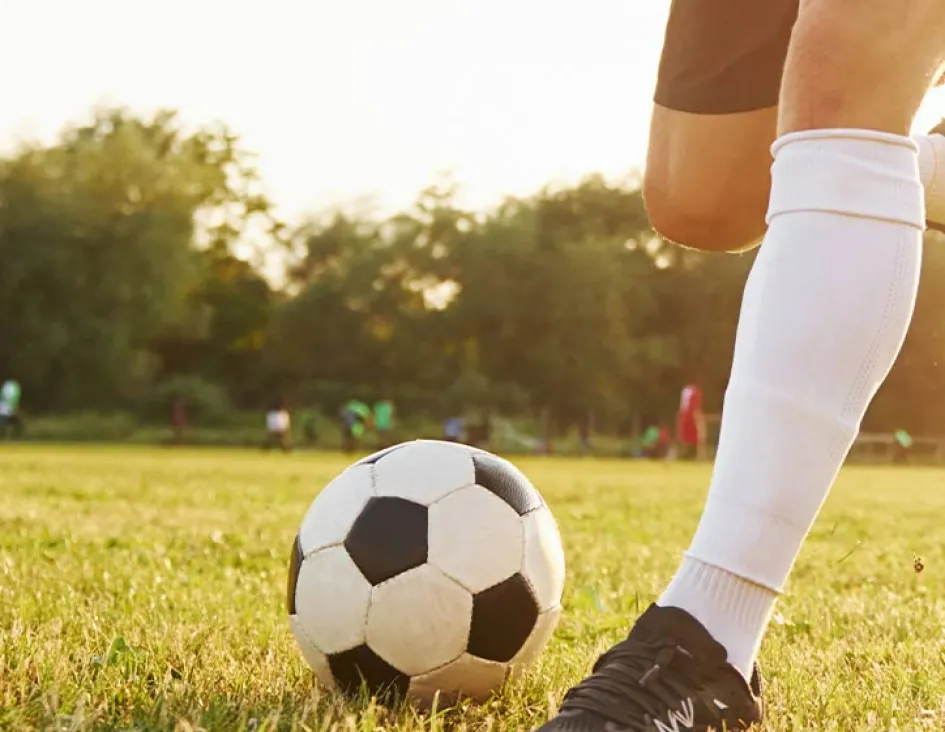 young adult playing soccer