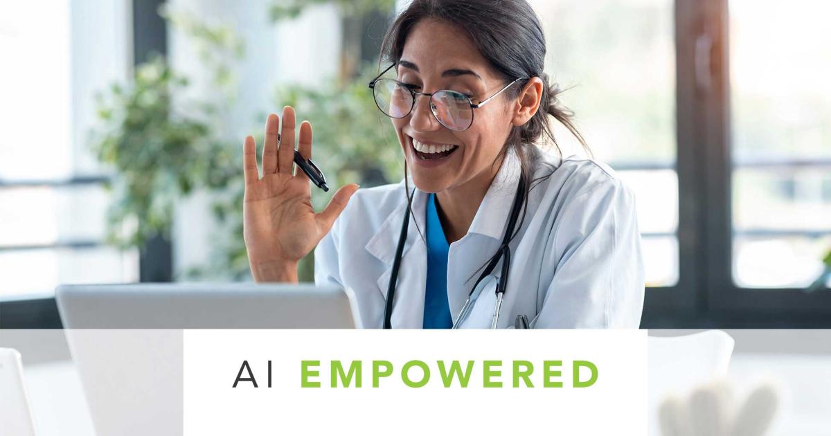 Doctor on a video call waving hand at computer screen