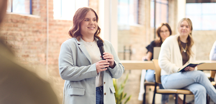 Elise presenting to an audience