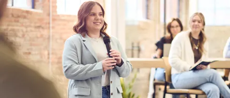 Elise presenting to an audience